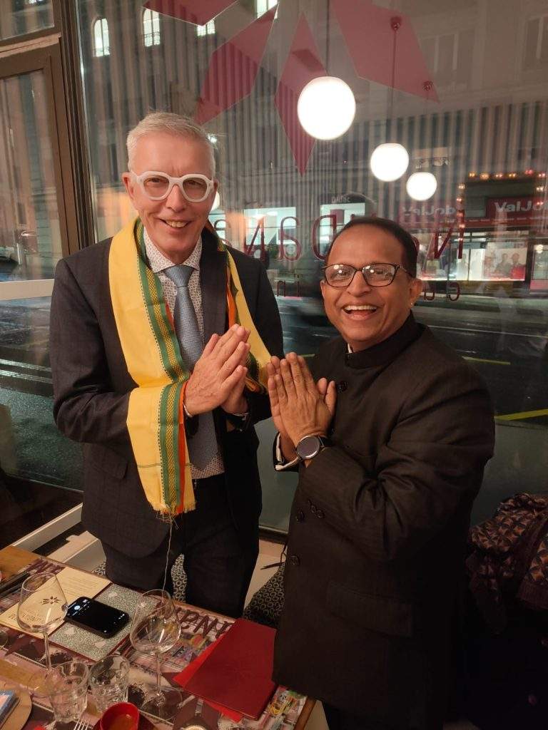 Deepalaya representative presenting a stole and artwork from Sambhav to Vision For All team in Switzerland